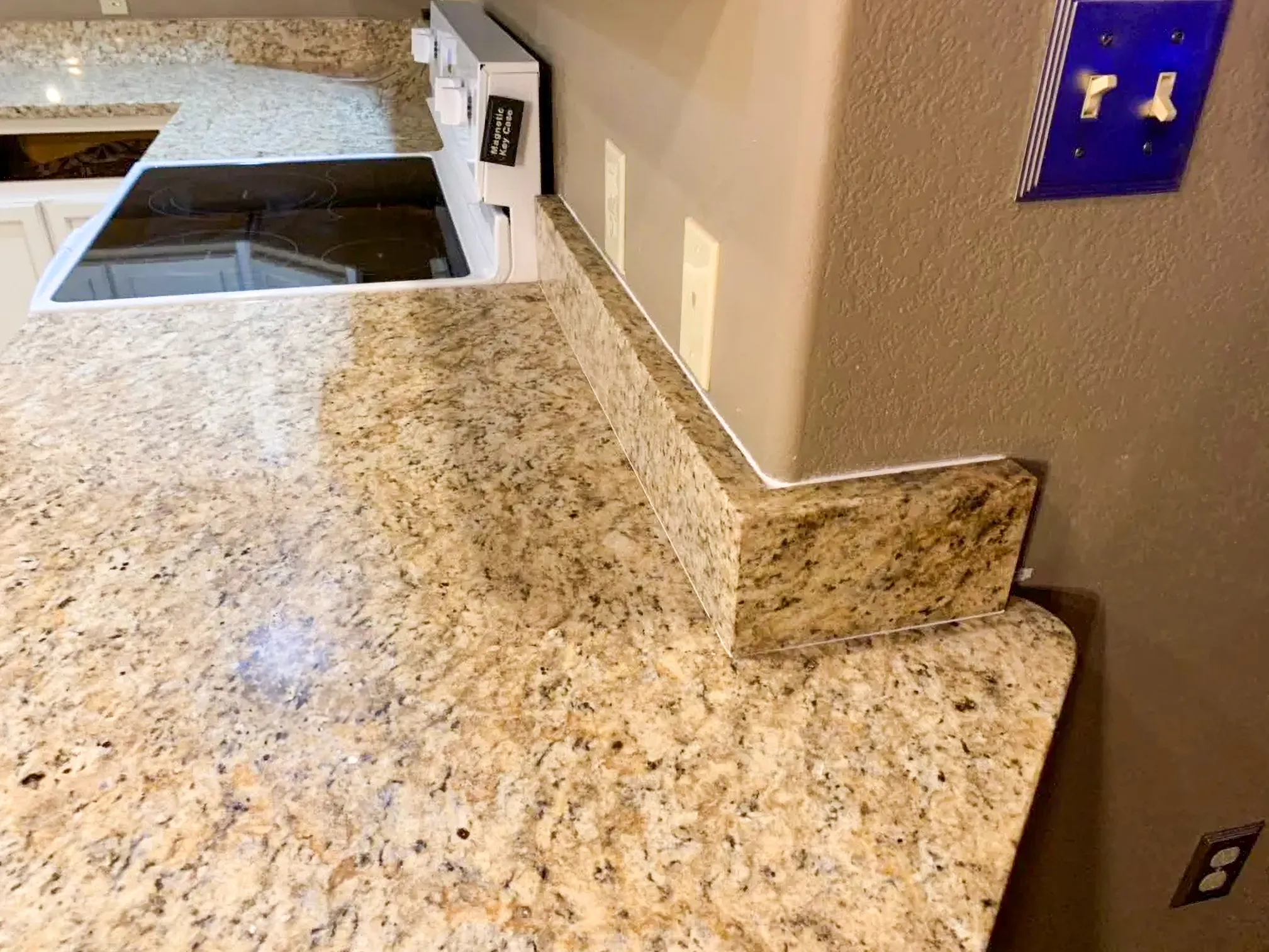 Close-up of premium granite countertop with matched backsplash