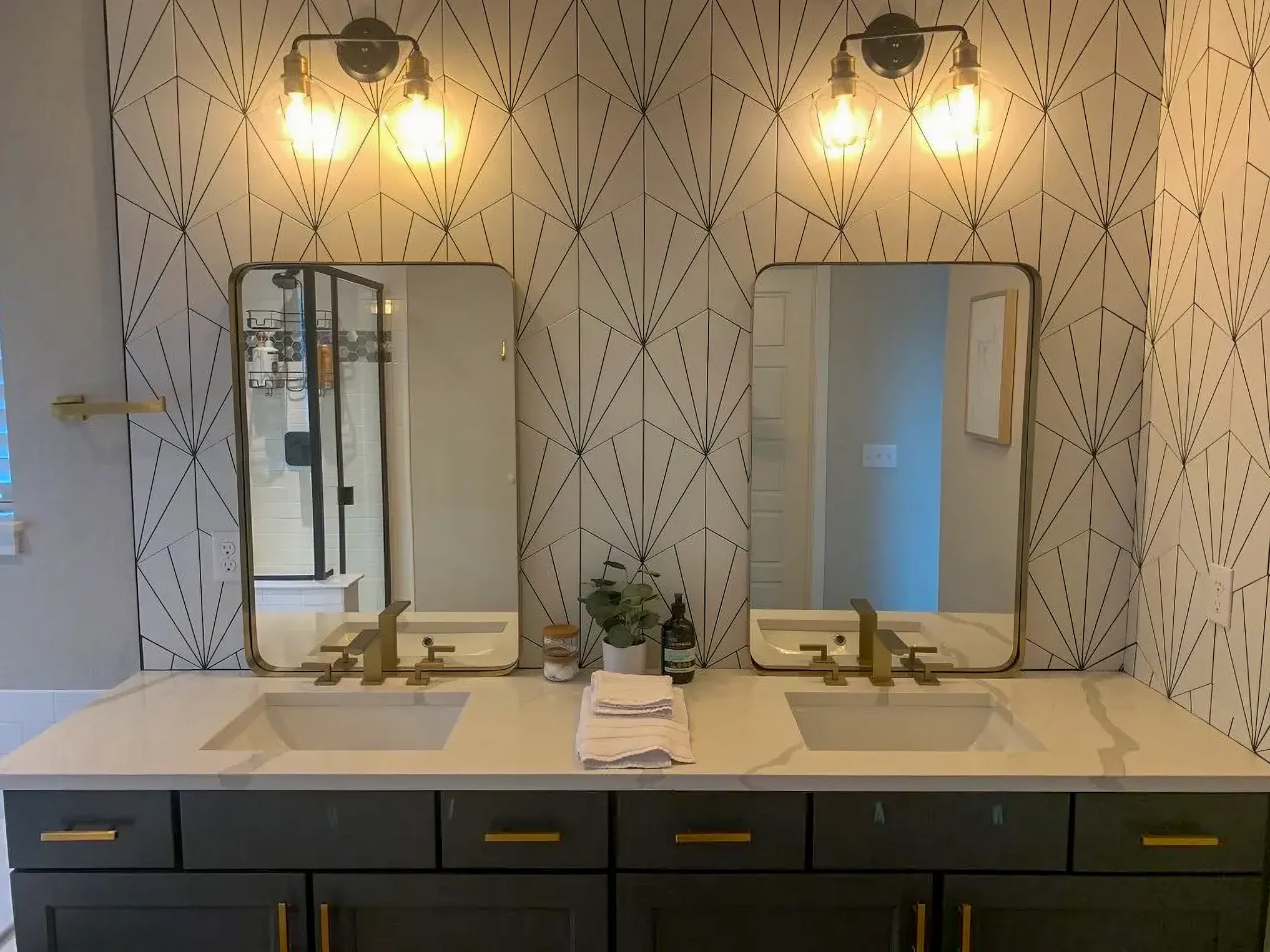 Modern dual vanity featuring gold hardware and veined quartz