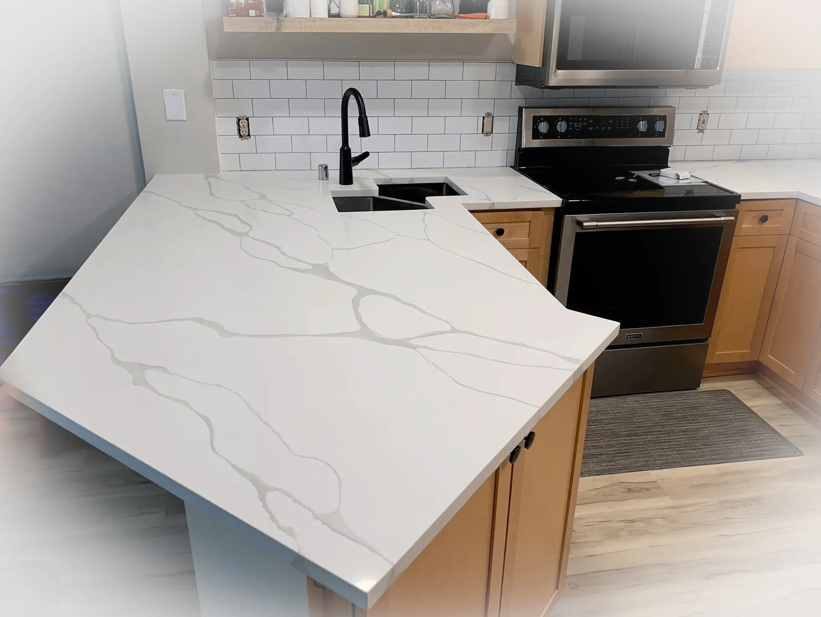 Premium kitchen redesign with elegant marble-look quartz and custom backsplash