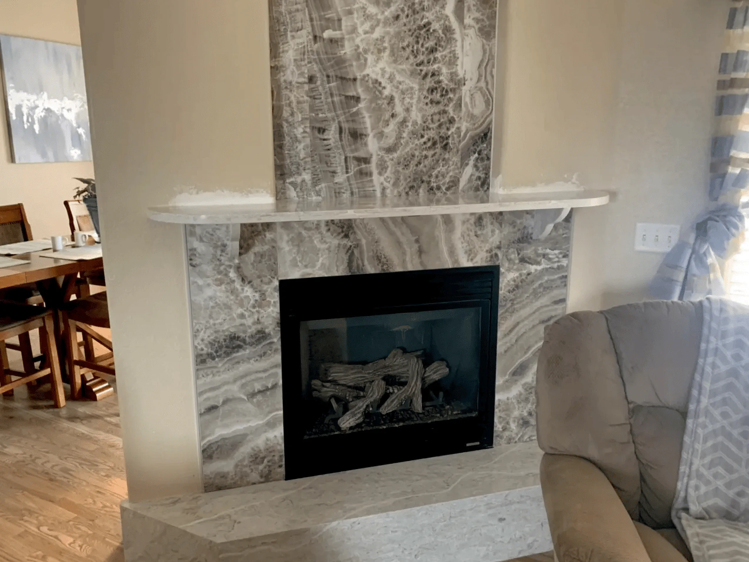 Elegant fireplace surround featuring book-matched natural stone