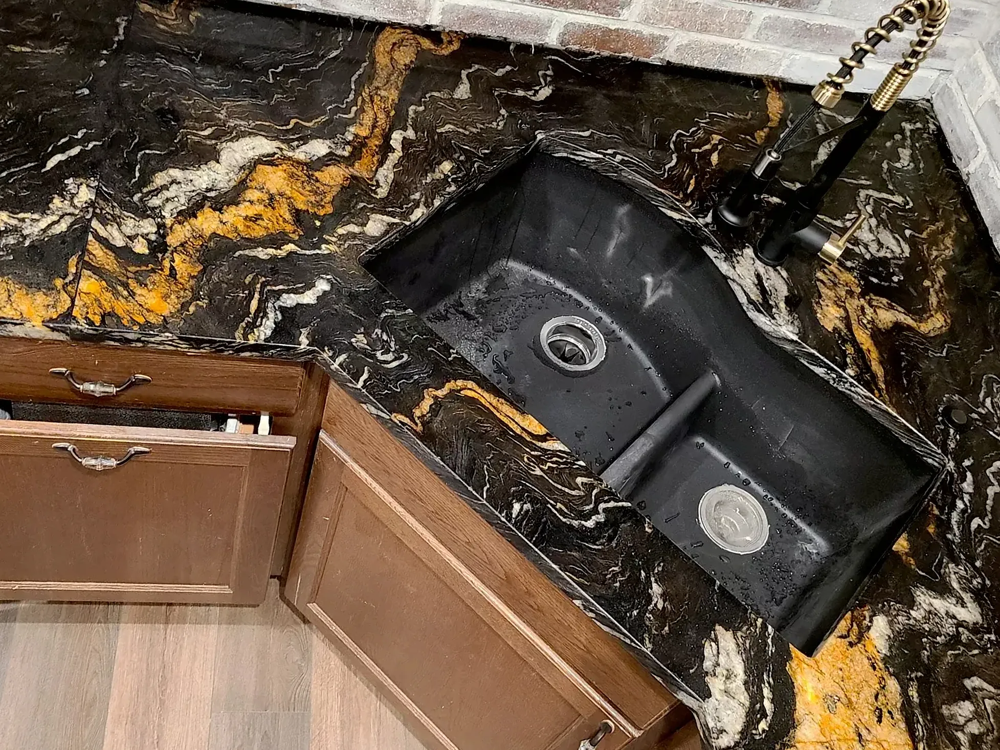 Luxury kitchen with dramatic black, gold, and white granite